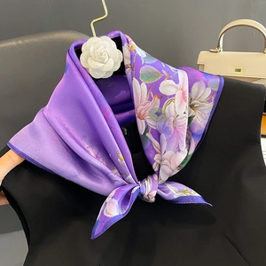 Elegant purple silk scarf featuring white magnolia print and camellia brooch detail