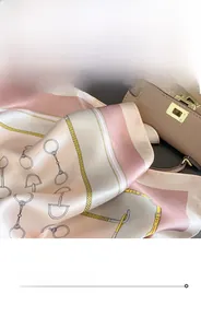 Detail of premium silk scarf featuring horsebit patterns and leather strap equestrian design