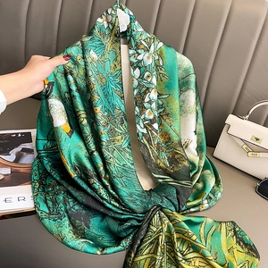 Elegant emerald green silk scarf with floral and bird print for beach and sun protection
