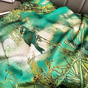 Silky green and ivory scarf featuring artistic bird prints and nature-inspired patterns