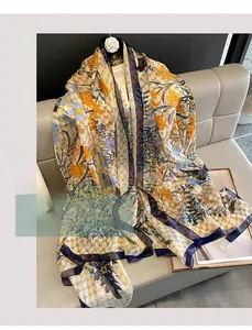 Detailed view of floral silk scarf with daisy patterns on a grey leather sofa
