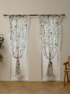 Detailed close-up of warm beige floral lace curtains with white chiffon ruffle edges