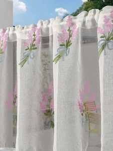 Detail of white semi-sheer cafe curtain with lavender embroidery and light blue bow