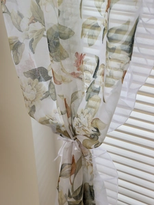 Detail of vintage floral sheer curtain with delicate ruffles and retro crochet pattern