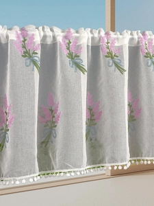 Close-up of lavender embroidery on semi-sheer cafe curtain with white pom-pom trim