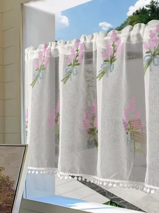 Detailed embroidery of lavender flowers and white pom-pom trim on a semi-sheer cafe curtain