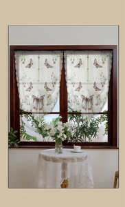 Detail of French butterfly embroidery on white semi-sheer Roman balloon curtain fabric