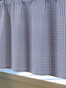Close-up of blue and white gingham fabric texture with natural soft folds for home decor