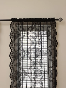 Detailed view of black floral lace curtain with delicate scalloped edges and mesh texture