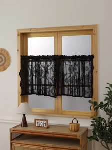 Macro detail of black vintage lace cafe tier curtains with delicate floral patterns