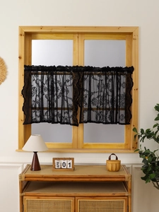 Macro shot of French vintage black lace cafe curtain with delicate floral embroidery patterns