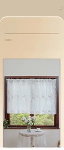 Detail of white lace curtain showing delicate plant leaf embroidery and texture