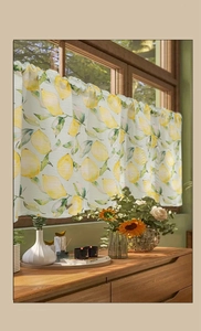Detail of yellow lemon print cafe curtain in cotton linen fabric with rod pocket header