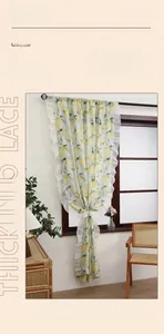 Detail of yellow lemon print curtains with elegant white lace ruffles and green fabric