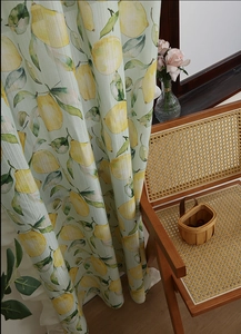 Detail of floral picnic tablecloth with lemon pattern on textured waterproof fabric
