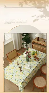 Detail of fresh yellow lemon print table cloth with checkered cotton linen texture
