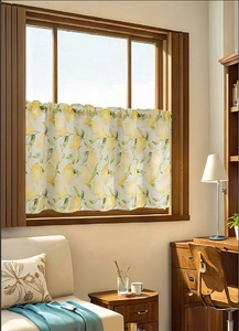 Detail of cream cafe curtain featuring a fresh lemon fruit and green leaf print pattern