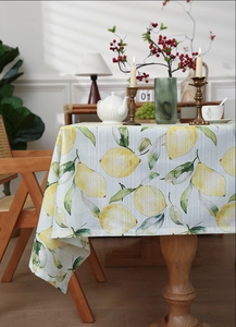 Detail of yellow lemon print tablecloth with premium cotton blend texture and neat edges