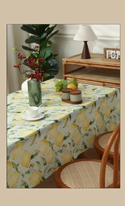 Detail of lemon print tablecloth with linen texture and fresh yellow fruit pattern