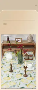 Detail of yellow lemon print tablecloth with rustic texture in a Nordic style setting