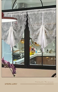 Close-up of white lace curtain featuring floral embroidery and elegant scalloped edges