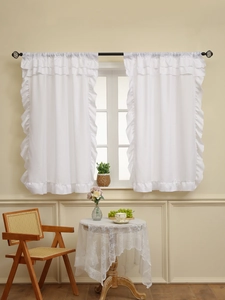 White semi-sheer cafe curtain with double ruffled edges on a vintage black rod