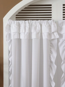 Close-up of elegant white ruffled sheer curtains with layered texture for home decor