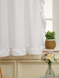 Close-up of white sheer curtain fabric with vertical texture and double ruffled edges