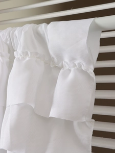 Detail of white ruffled layered curtain with subtle diagonal weave and textured fabric