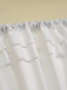 Close-up of white semi-sheer curtain with elegant multi-layer ruffled pleats and textures