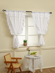 Close-up of white semi-sheer cafe curtains with ruffled edges and delicate textures