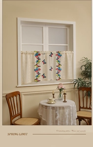 Detail of oil painting butterfly pattern on short cafe curtains with lace edges