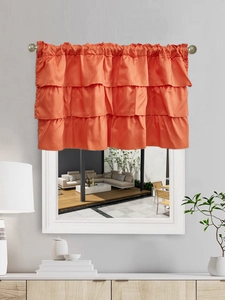 Close-up of vibrant orange triple-layered ruffle window valance with satin finish texture