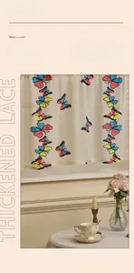 Detailed close-up of thickened lace curtain with colorful butterfly embroidery patterns