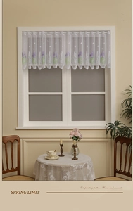 Detail of white lace short curtain featuring purple lavender embroidery and scalloped edges