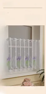 Close-up of thickened lace curtain with lavender floral print and woven details