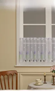Detail view of white sheer cafe curtain with lavender embroidery and wavy edges