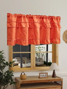 Close-up of triple-layered orange ruffled valance with elegant white edge detailing