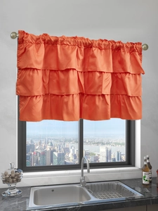 Detail of orange satin tiered valance curtain with triple-layered ruffles for kitchen