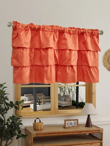 Close-up of bright orange triple ruffled cafe curtain with a sleek satin finish