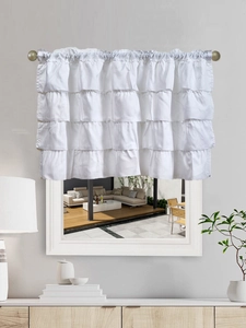 Close-up of a white four-layer tiered ruffled valance curtain on a metal curtain rod
