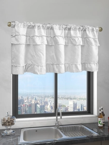 Close-up of white triple-layered ruffle cafe curtains with a rod pocket header design