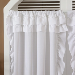 White semi-sheer curtain featuring layered ruffle edges and pleated top for living room