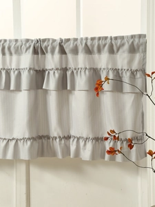 Detail of grey tiered ruffle curtain fabric with striped texture and elegant folds