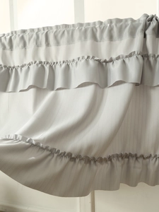Detail of light gray ruffled cafe curtain with fine vertical striped texture and soft drape