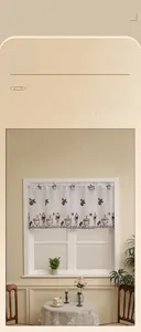 Detail of coffee-themed embroidery on white sheer fabric with scalloped wave edges