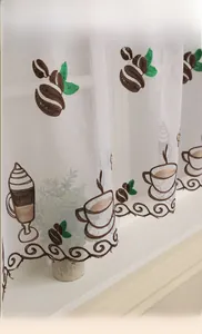 Detail of white cafe curtain with coffee embroidery and brown scrollwork borders