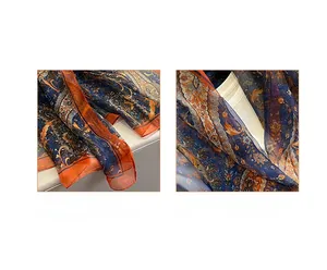 Detailed view of paisley print silk scarf with digital printing and reinforced edges