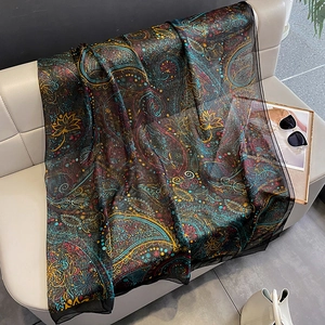 Detailed texture of bohemian paisley silk scarf with lotus pattern and soft chiffon fabric