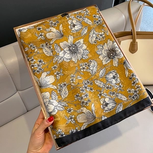 Elegant floral silk scarf with yellow and black patterns in a stylish gift frame